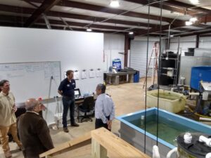 (Ashok Goel (bottom left) and Sandeep Kakar (right) tour North Georgia Technical College with Environmental Technology Instructors Duncan Hughes (right) and Kevin Peyton (left) Photo: AI-ALOE)